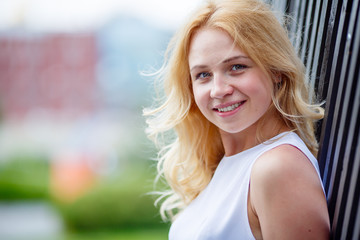 Portrait of young woman near wall