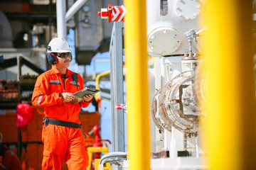 operator recording operation of oil and gas process at oil and rig plant, offshore oil and gas...