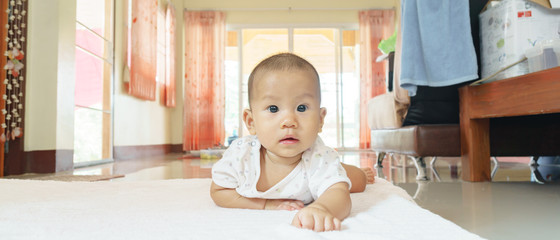 Asian baby lying on stomach
