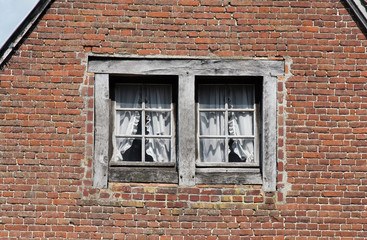 They say you can see soul of the house in it's windows..  Windows on the facade of old house in Pont-l'Eveque, Normandy, France