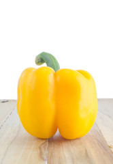 yellow bell pepper on wooden
