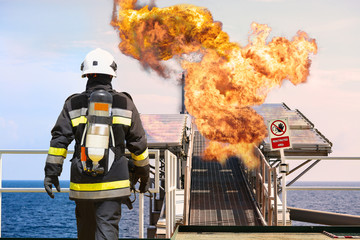 Fire fighter on oil and gas industry, successful firefighter at work , Fire suit for fighter with...