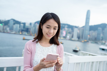 Woman using cellphone in Hong Kong