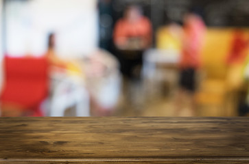 Selected focus empty brown wooden table and Coffee shop blur bac