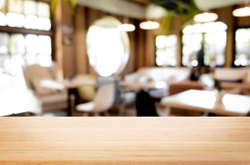 Fototapeta na wymiar Selected focus empty brown wooden table and Coffee shop blur bac