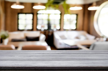 Selected focus empty brown wooden table and Coffee shop blur bac