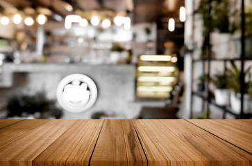 Selected focus empty brown wooden table and Coffee shop blur bac