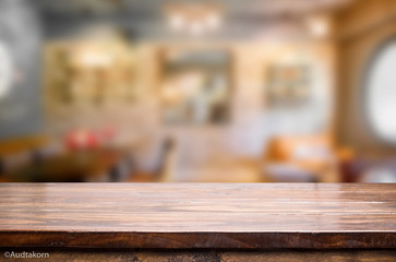Selected focus empty brown wooden table and Coffee shop blur bac