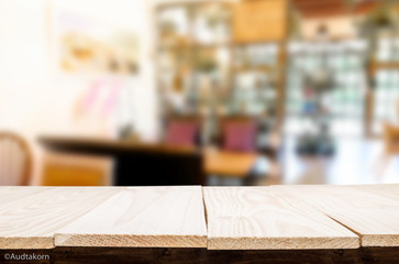 Selected focus empty brown wooden table and Coffee shop blur bac