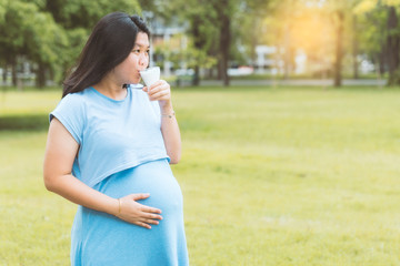 Pregnant woman drinking organic milk with a copy space. (Vintage tone) Can use for healthy food concept background.