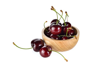 fresh cherry with stem in wooden bowl and on white background