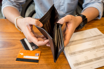 credit card debt - holding an empty wallet. - obrazy, fototapety, plakaty