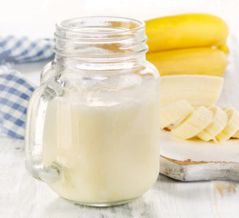 Fresh made Banana smoothie on a wooden table.