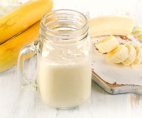 Fresh made Banana smoothie on wooden background.