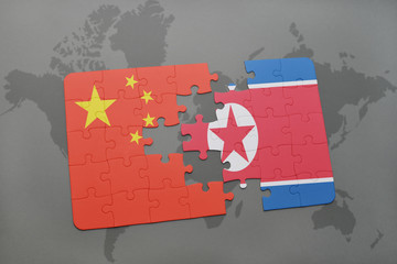 puzzle with the national flag of china and north korea on a world map background.