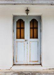 Old wooden door with  White cement wall