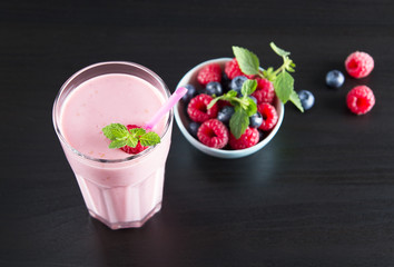 Glass of fresh cold smoothie with raspberry