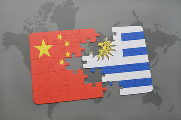 puzzle with the national flag of china and uruguay on a world map background.