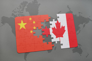 puzzle with the national flag of china and canada on a world map background.