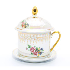 Antique porcelain tea cup on white background