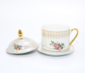 Antique porcelain tea cup on white background