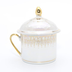 Antique porcelain tea cup on white background