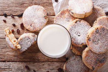 Tasty Welsh cakes with raisins and milk close-up on the table. horizontal top view
