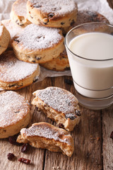 Homemade Welsh cakes with raisins and milk close-up. vertical
