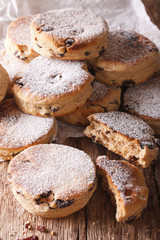 British biscuits: Welsh cakes with raisins and powdered sugar close-up. Vertical
