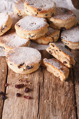 Fried Welsh cakes with raisins and powdered sugar close-up. vertical
