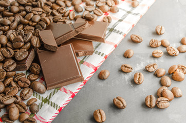 Broken slices of chocolate and coffee beans