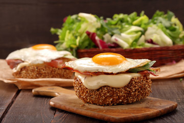 Sandwich with cheese bacon and fried egg