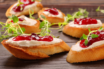 Toast with white cottage cheese cherry jam and fresh herbs