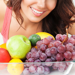 Woman with plate of fruits, outdoors