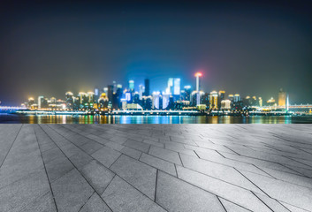 empty tiled floor before city skyline and cityscape