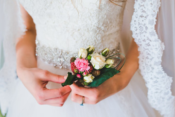 Wedding buttonhole in bridal hands
