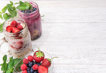 Chia seeds  pudding and berries and smoothies with fresh berries in glass on wooden background. Vegetarian concept.