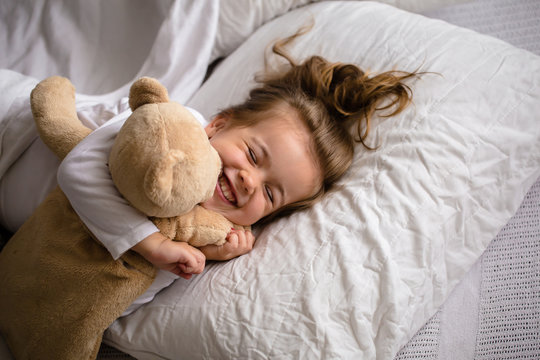 little girl in bed with soft toy the emotions of a child
