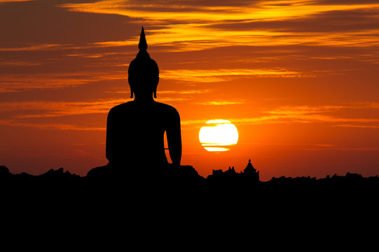 Silhouette public big white Buddha, sunset in Thailand