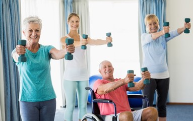 Fototapeta na wymiar Seniors exercising with weights