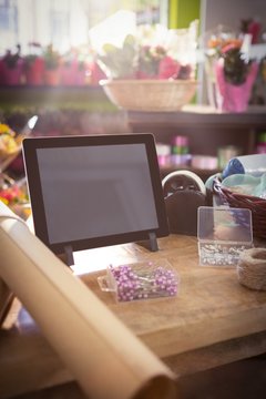 Digital tablet and florist supplies on the wooden table