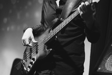 Fototapeta premium Rock and roll music, bass guitar player closeup