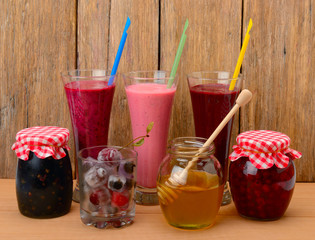 Set of berry smoothies, jams and frozen berries