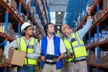 Worker looking up in warehouse