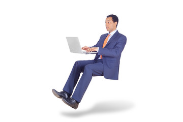 Businessman flying sitting with laptop