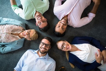 Business team lying on the floor with head together