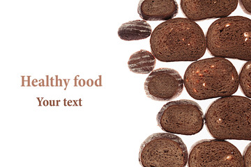 Decorative edging pieces of black rye bread on a white background. Isolated. Border. Pattern. Food background. View from above.