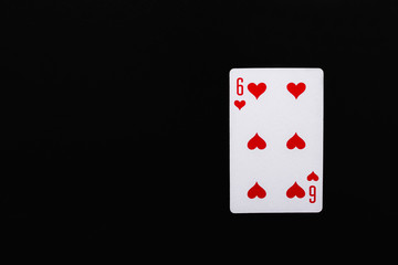 Playing card. Six of hearts on a black background