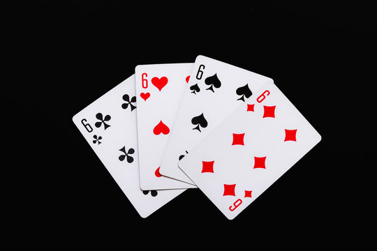 playing cards of four sixes on a black background