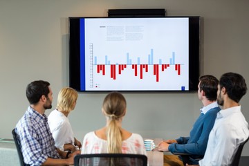 Business people discussing over graph during a meeting